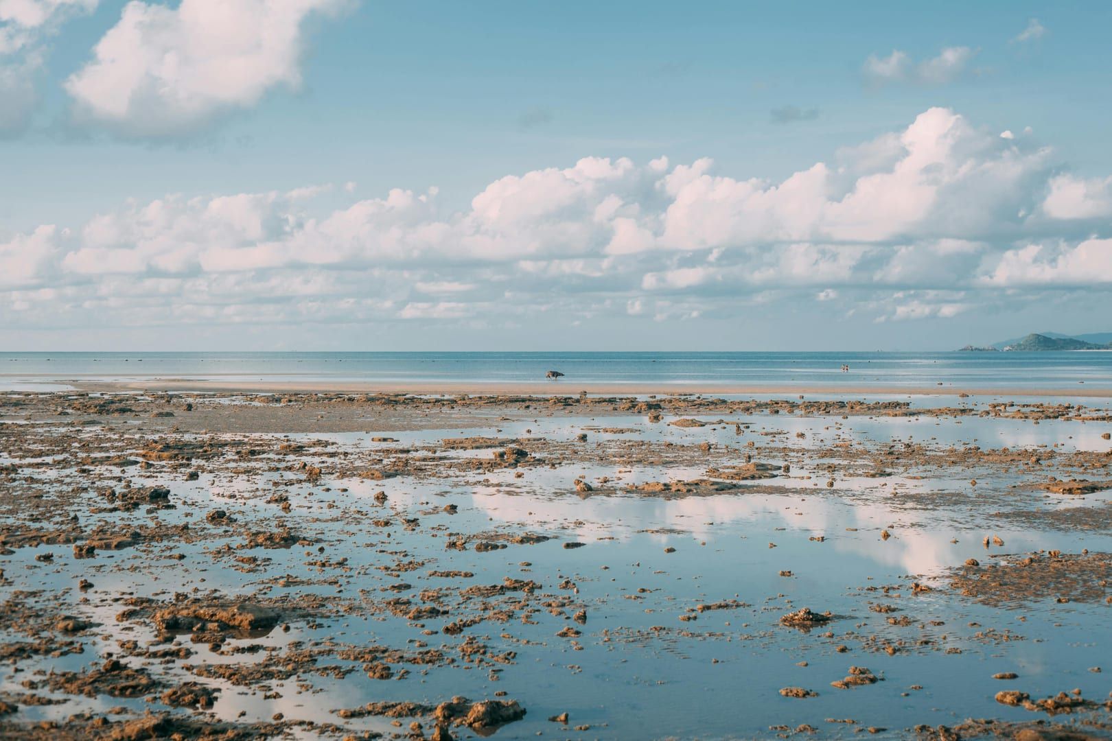 Low tide reflections at Bophut Beach Samui with serene sky