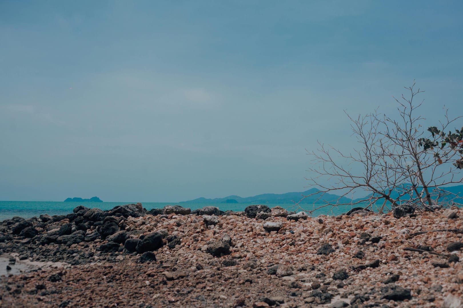 Rocky coastline at Bophut Beach with views of Koh Phangan island