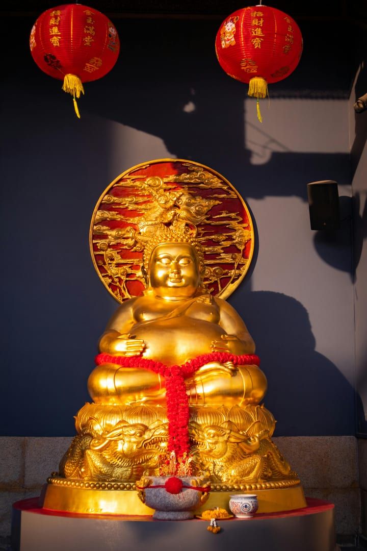 Detailed wooden altars and gold leaf calligraphy