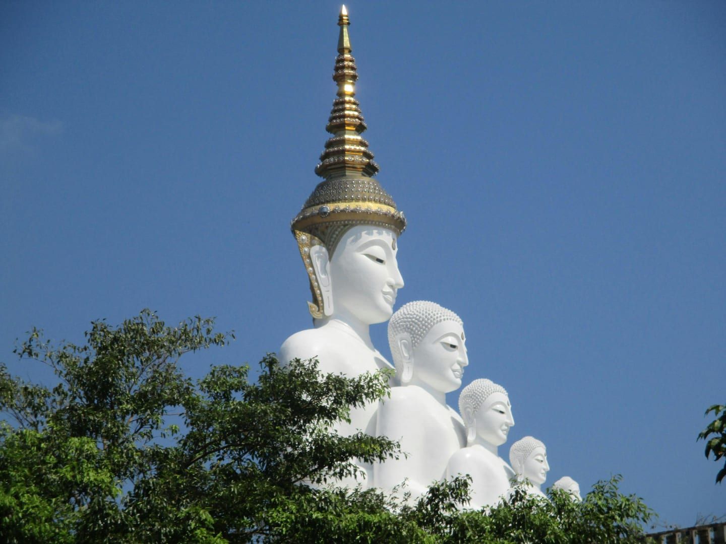 Golden Buddha statue facing the sea at Wat Khao Chedi Samui