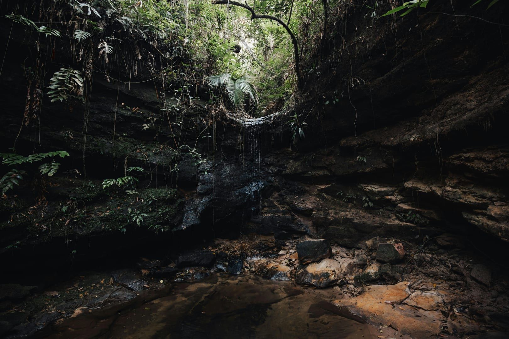 The shaded natural pool at the base of Secret Falls